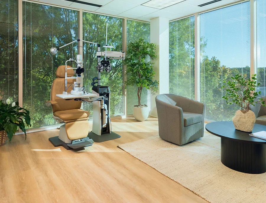 Contact lens examination suite with diagnostic equipment and floor-to-ceiling windows