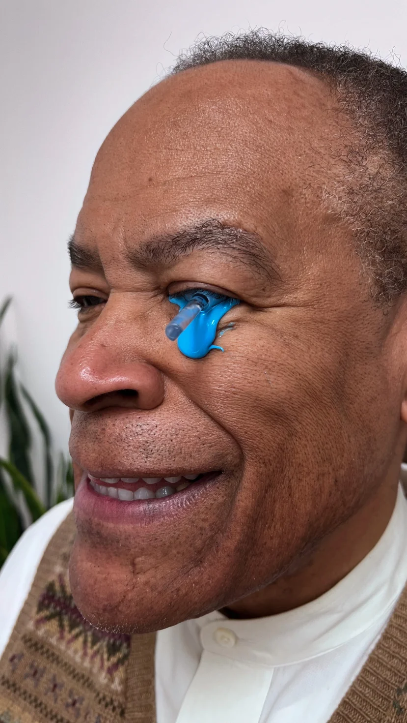 Patient smiling during consultation for custom EyePrintPRO scleral lenses at The Raleigh Contact Lens Institute
