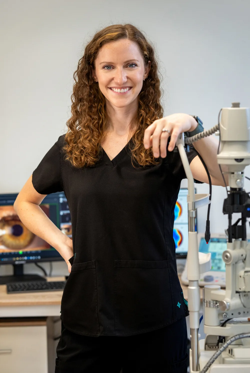 Eye specialist conducting an advanced diagnostic exam at The Raleigh Contact Lens Institute