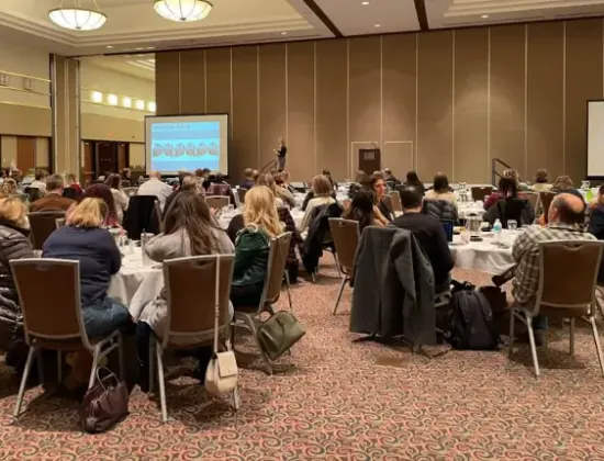 Auditorium of optometrists and eye care professionals at clinical education conference